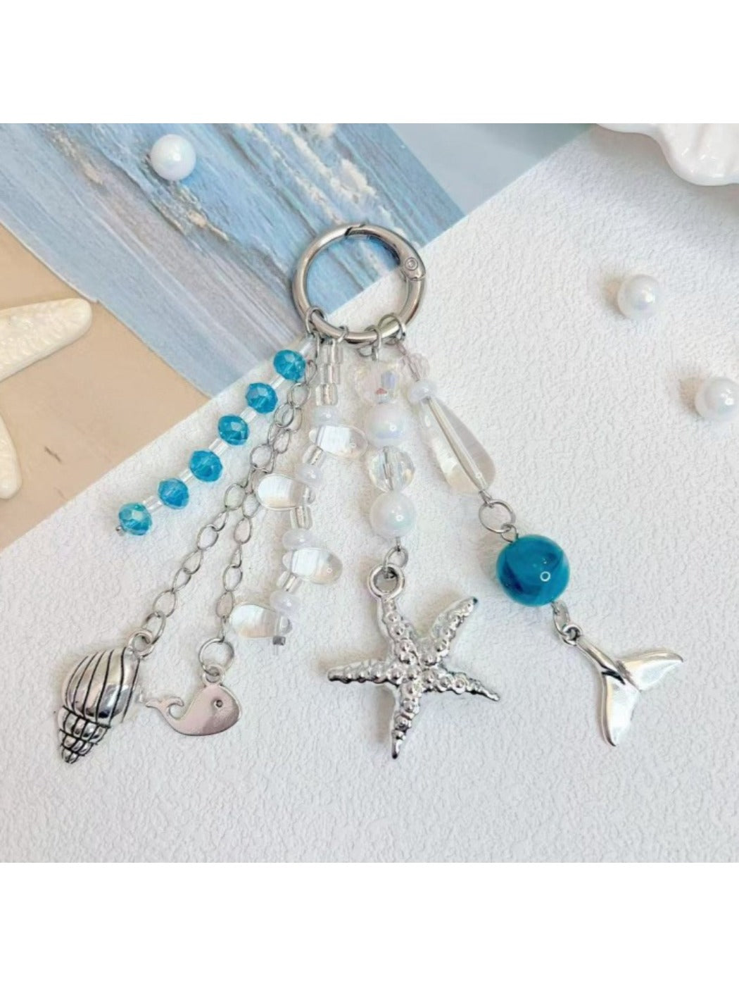 Ocean themed pendant keychain with blue and turquoise enamel and silver key ring