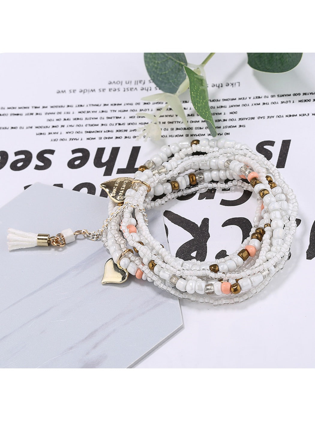 Lovra beaded bracelet worn on wrist highlighting heart pendant and bead colors