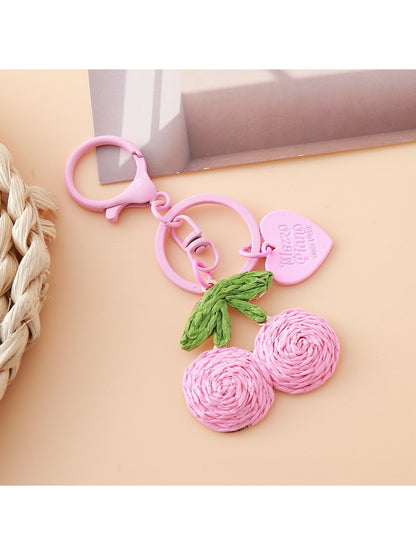 Multiple Keypus cherry charm keychains arranged in a row on a pastel background