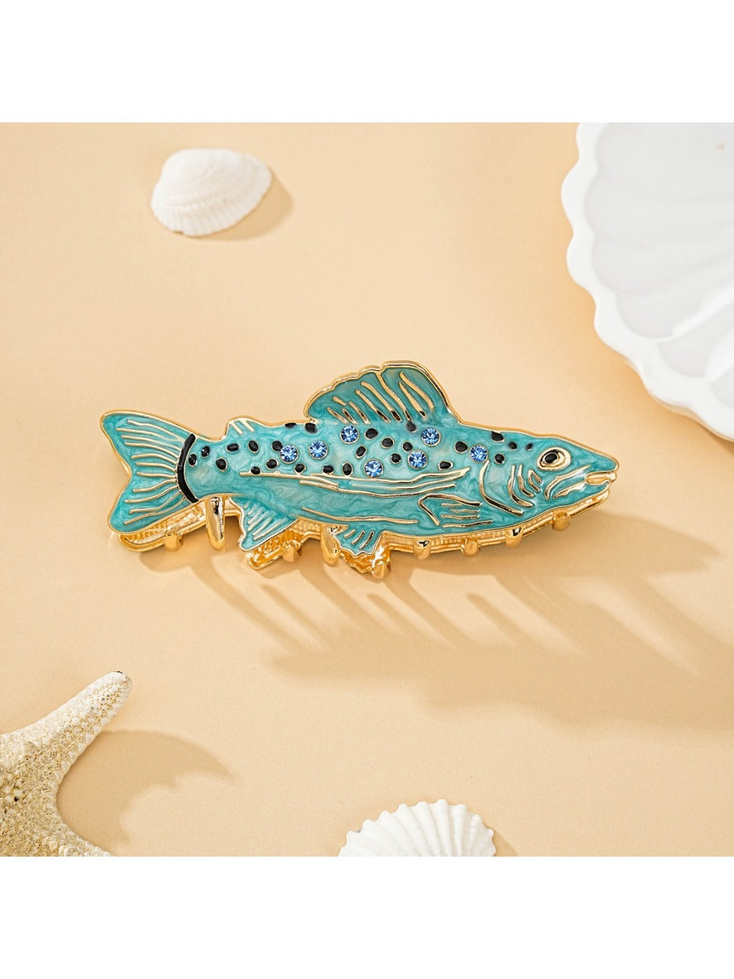 Close-up of engraved name on wooden fish shaped hair clip with smooth finish
