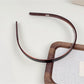 Model wearing Gifty solid color acetate headband with silky smooth finish