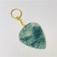 Side view of the textured teardrop charm keychain showing its thickness and detail