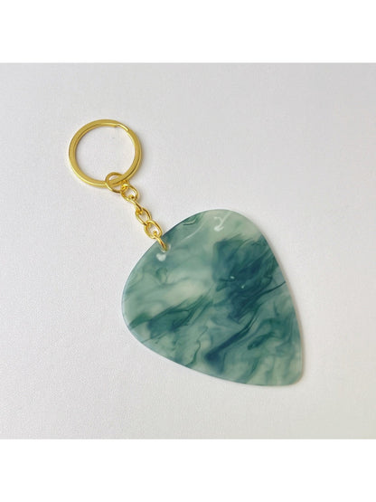 Side view of the textured teardrop charm keychain showing its thickness and detail