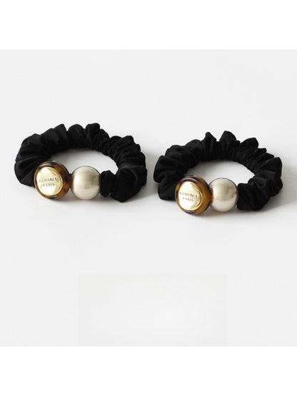 Gifty minimalist modern round bead hair tie in black on white background