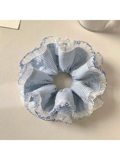 Close-up of navy blue striped scrunchie showing fabric texture and elastic band