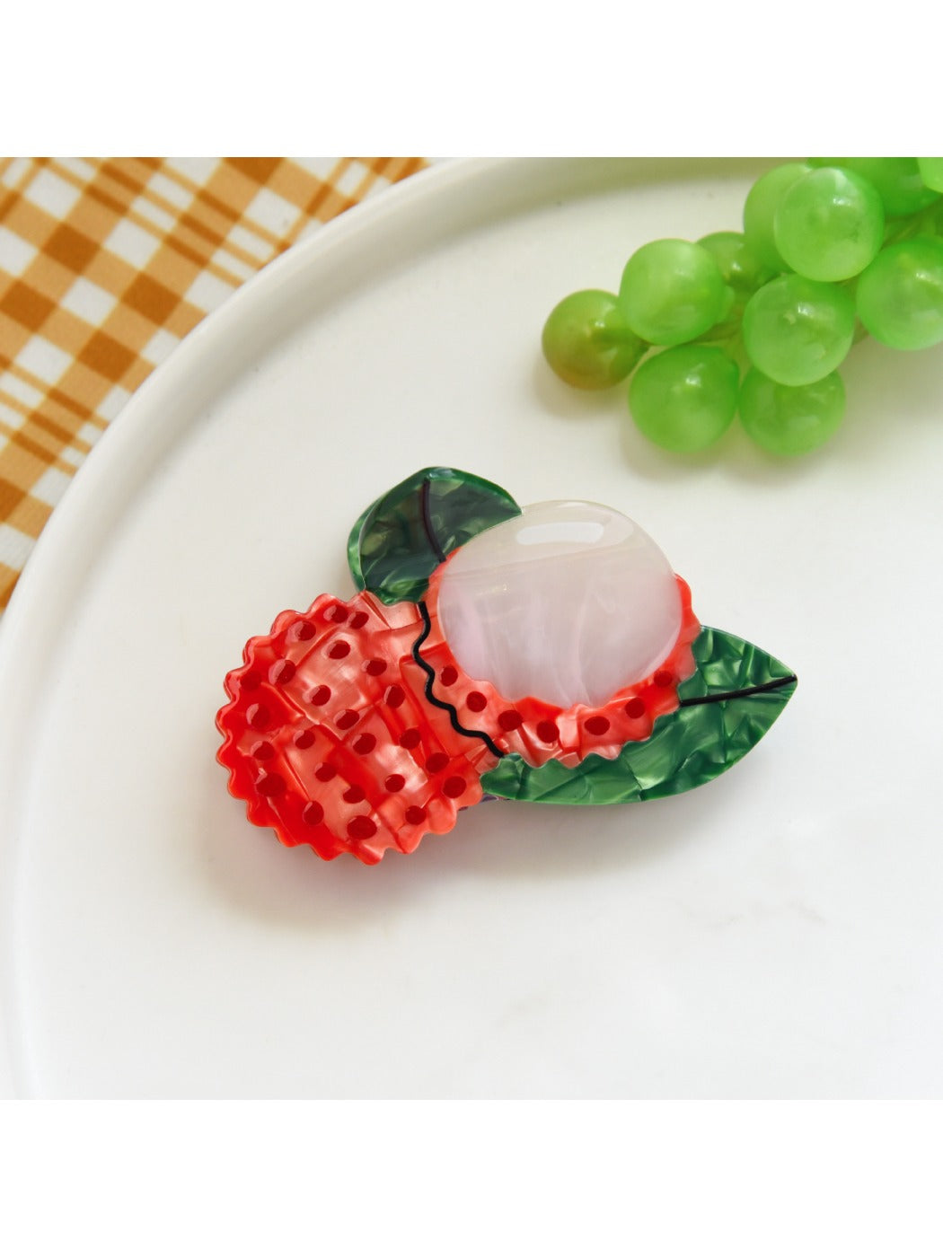 Orange slice hair clip displayed on a flat surface with natural lighting