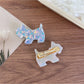 Close-up of Beau puppy hair clip showing smooth acetate texture and glossy finish