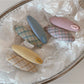 Beau colorful oval hair clip with multicolor resin design on white background