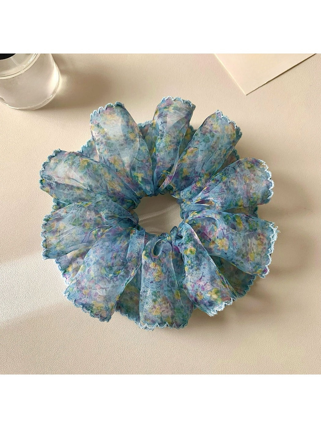 Gifty scrunchie worn on a model's wrist showcasing vintage floral print