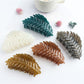 Beau stylish leaf shaped hair clip on white background