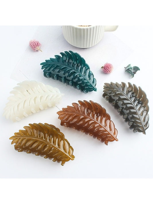 Beau stylish leaf shaped hair clip on white background