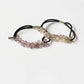 Side view of Gifty hair tie highlighting the arrangement of colorful beads on elastic