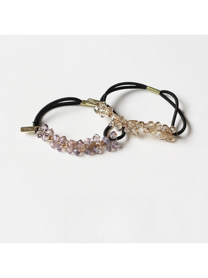 Side view of Gifty hair tie highlighting the arrangement of colorful beads on elastic