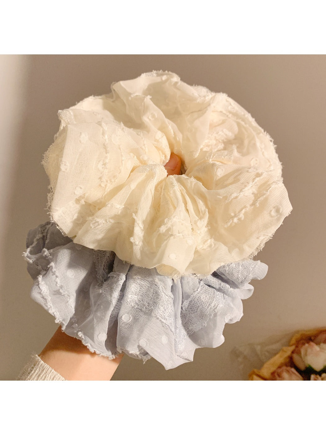 Gifty ruched scrunchie wrapped around a ponytail on a model
