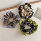 Close-up of Gifty color block print scrunchie with pink, orange, and white sections