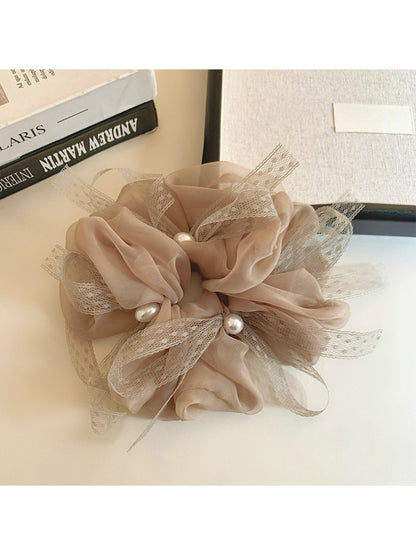 Gifty scrunchie displayed on a white background emphasizing its elegant bow