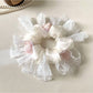 Close-up of Gifty floral scrunchie showing fabric texture and flower details