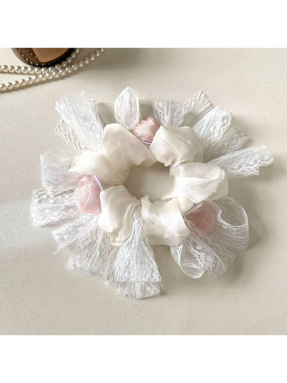 Close-up of Gifty floral scrunchie showing fabric texture and flower details