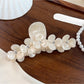 Beau floral half round claw clip displayed on a wooden surface