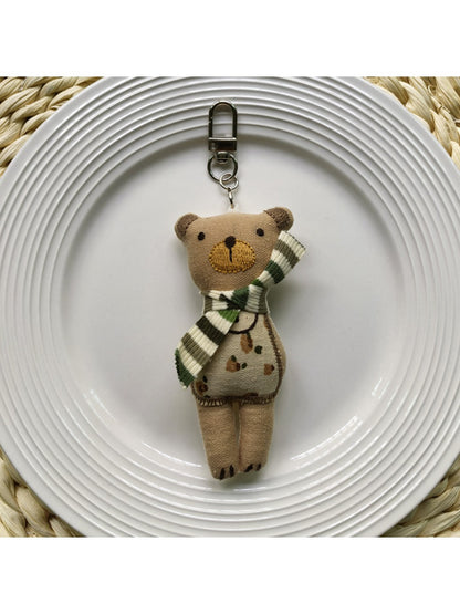 Fabric bear cub bag charm keychain displayed with a set of keys