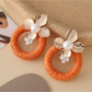 Earedge round floral pendant earrings with gold-tone finish and floral motifs