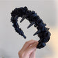 Gifty sleek minimalist twist headband folded to show flexibility