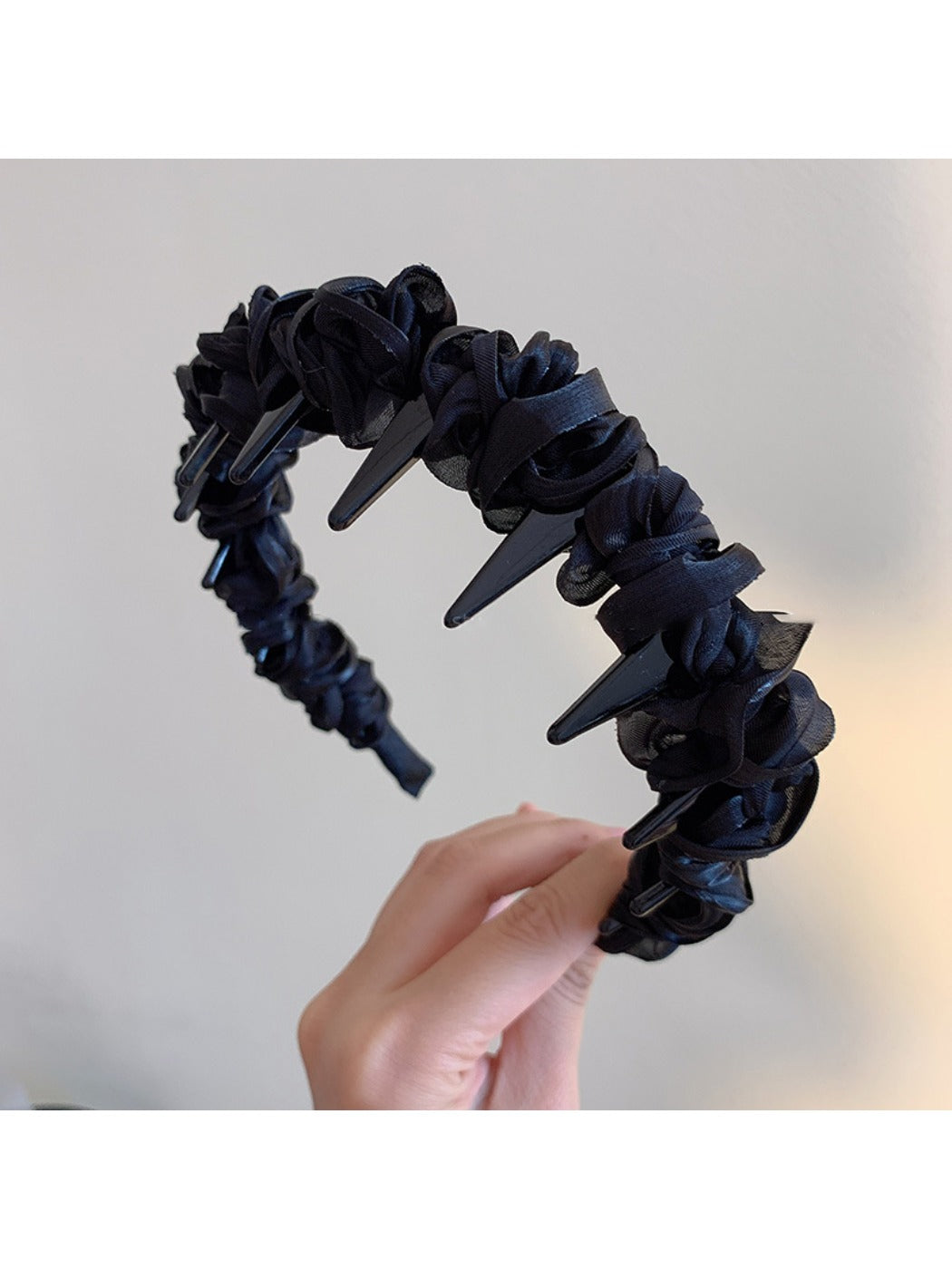 Gifty sleek minimalist twist headband folded to show flexibility