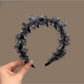 Close-up of leopard print tulle fabric and bow on headband