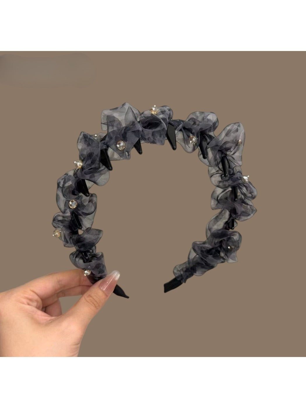 Close-up of leopard print tulle fabric and bow on headband