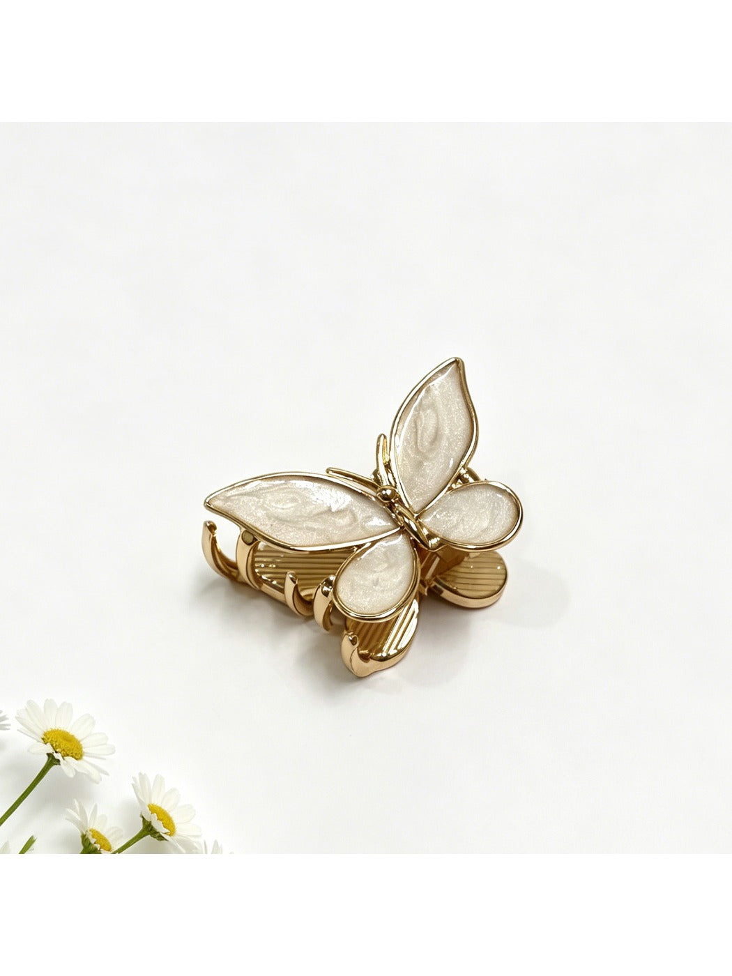 Close-up of Beau butterfly hair clip showing smooth curved edges and clasp mechanism