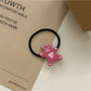 Flat lay of minimalist rose hair accessories including ties and clips