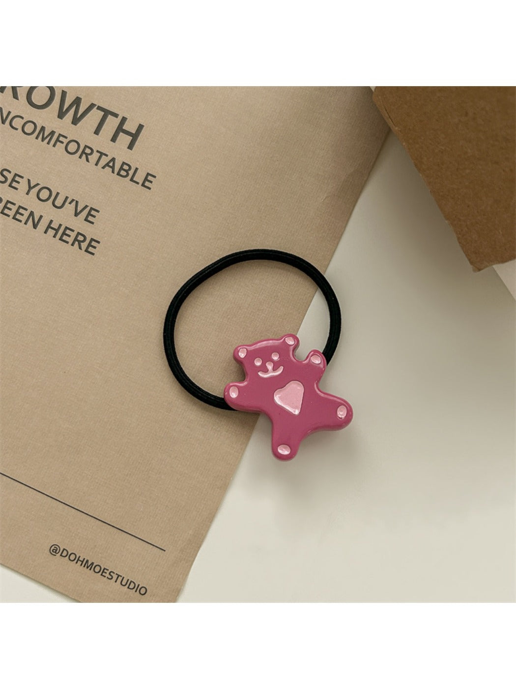 Flat lay of minimalist rose hair accessories including ties and clips
