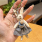 Rabbit charm keychain displayed with other metallic accessories