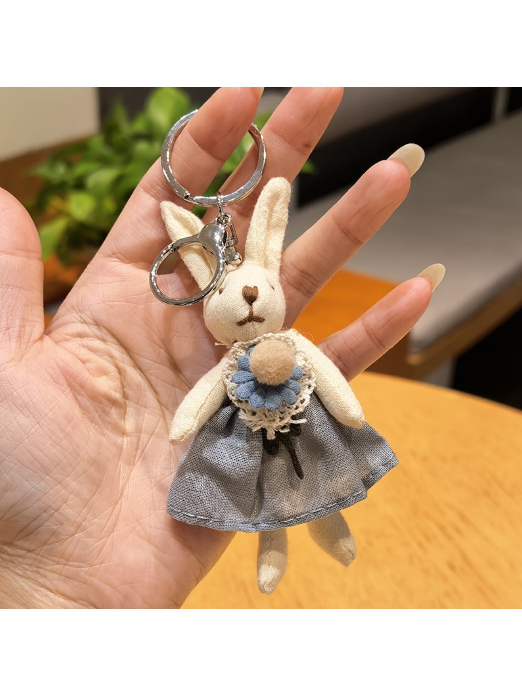 Rabbit charm keychain displayed with other metallic accessories