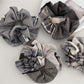 Gifty plaid patchwork scrunchie with mixed red, green, and beige fabric patterns