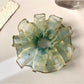 Vintage minimalist ombre hair scrunchie in soft pastel colors on a white background