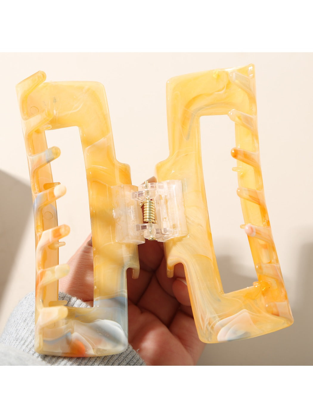 Side view of Beau rectangular hair clip highlighting its slim profile and clasp mechanism