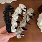Gifty satin headband with black and white polka dot pattern on a white background