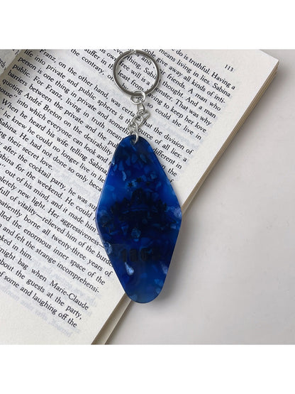Side view of the colorful diamond pendant keychain showing thickness and metal ring