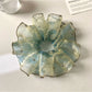 Close-up of ombre hair scrunchie showing fabric texture and color gradient