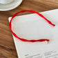 Side view of Gifty Pure Simple Style Headband worn on dark hair