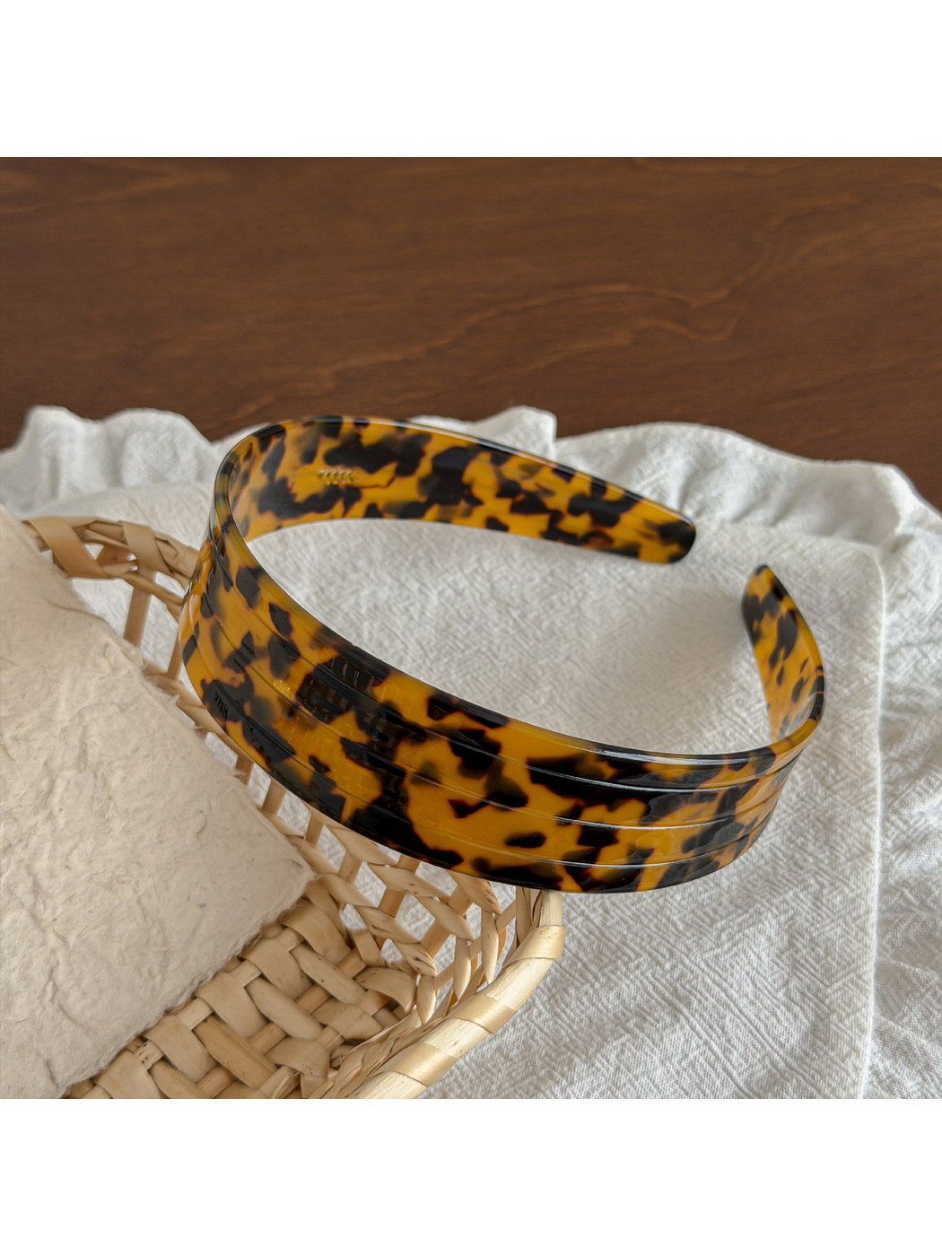Gifty acetate headband shown with a close-up of the geometric pattern details