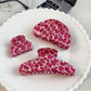 Side view of Beau pink leopard print half round claw clip highlighting claw teeth