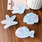 Side view of Beau blue ocean style claw clip with curved claws visible