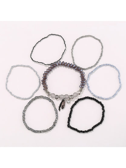 Close-up of Lovra multi-row bracelet showing detailed gold and black bead design