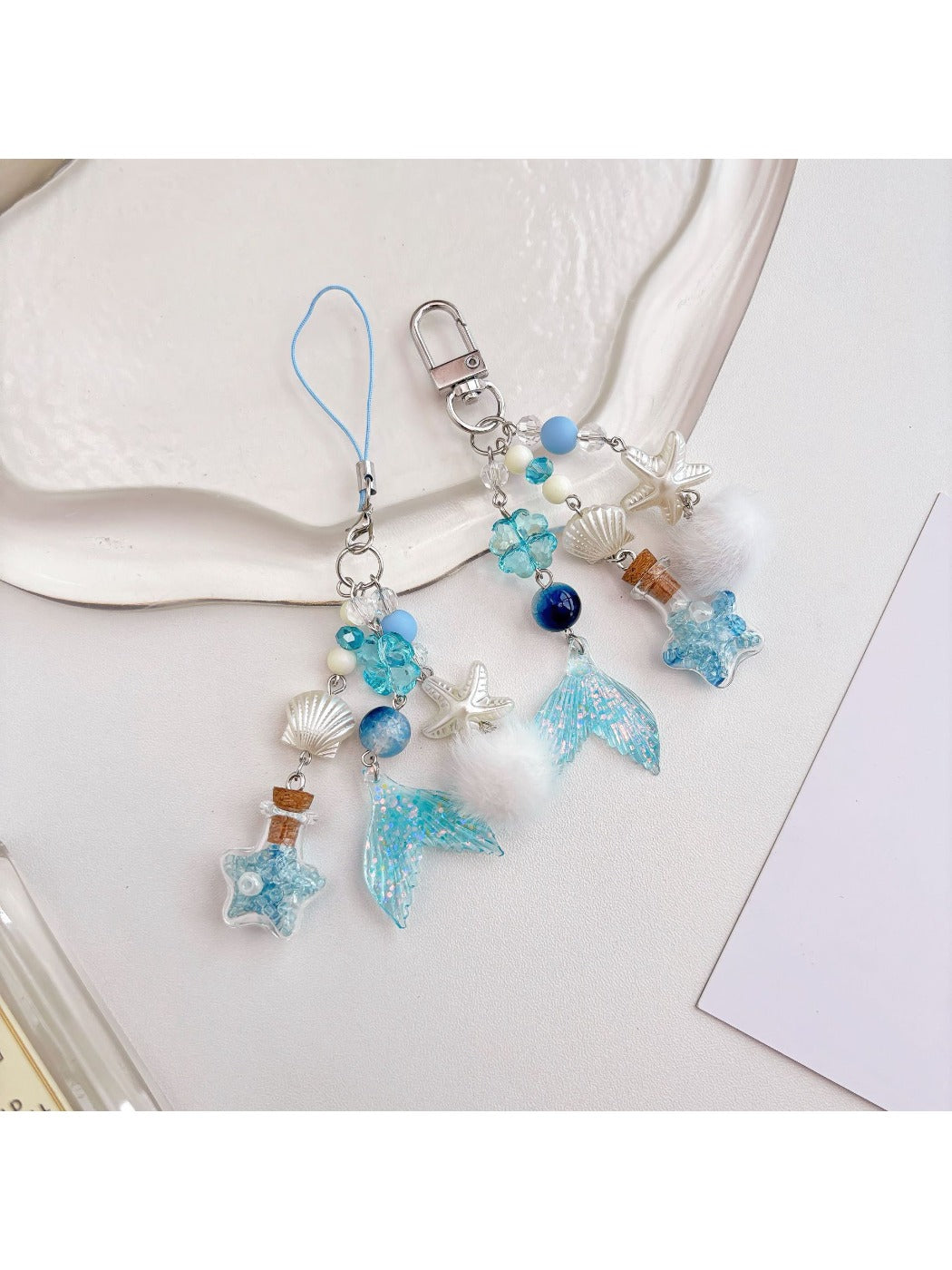 Keychain attached to a set of keys featuring the blue drift bottle charm