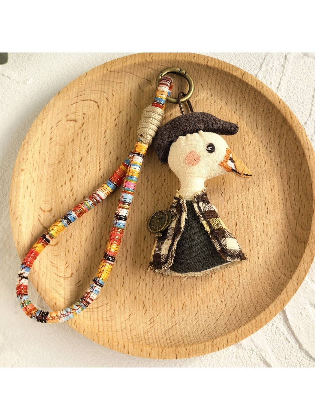 Back view of Keypus cartoon doll keychain showing plain fabric surface