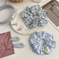 Elegant scrunchie headband in soft fabric with gathered design