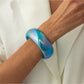 Lovra bangle bracelet stacked with other bracelets on wrist