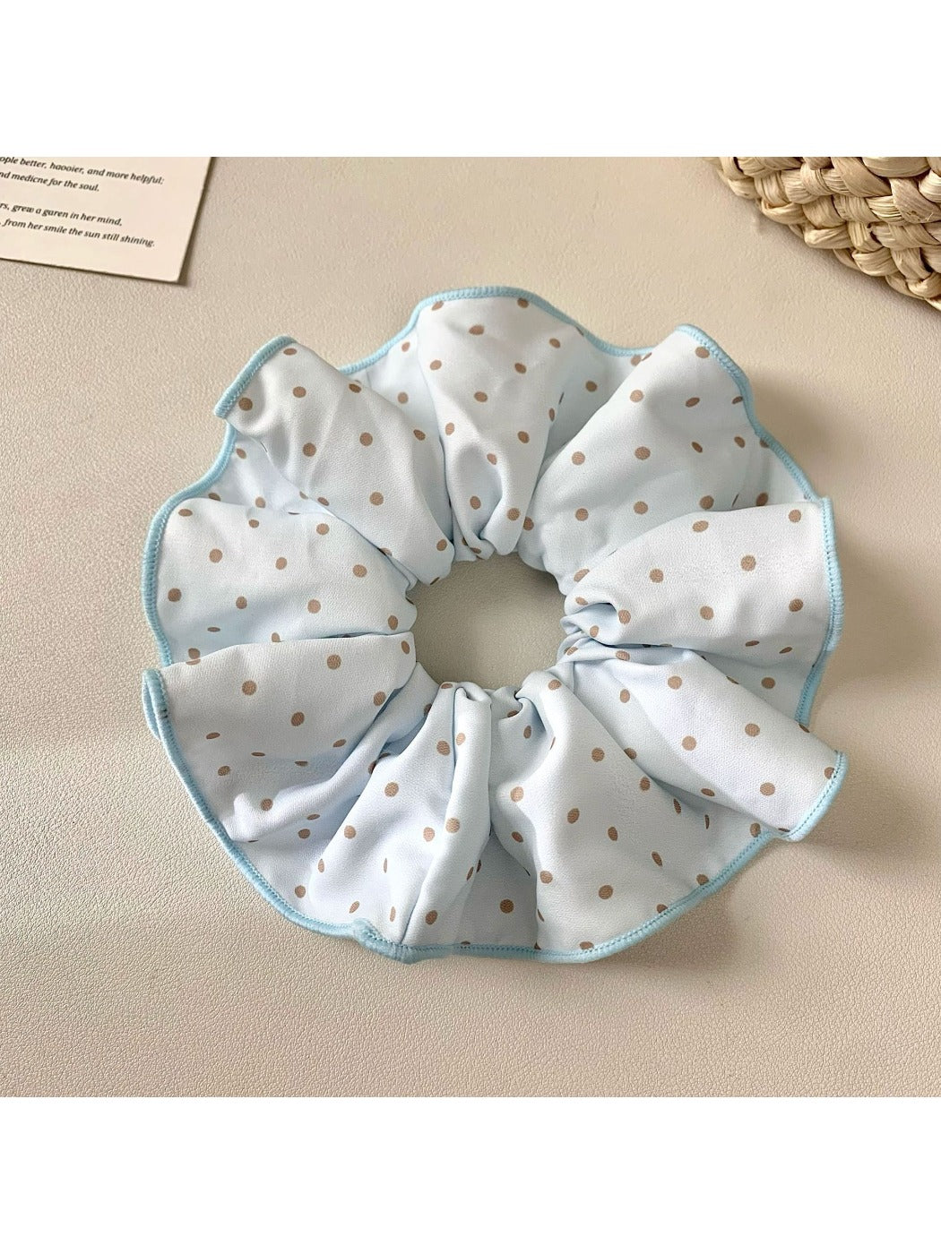 Close-up of Gifty solid color polka dot scrunchie on white background